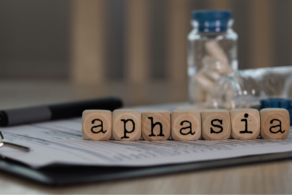 Wooden letters spell the word 'aphasia'.